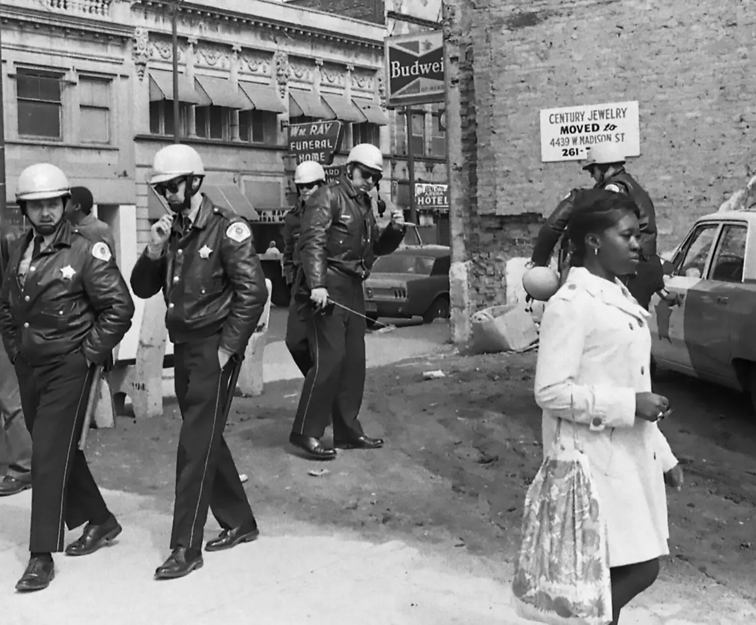 In 1968, amid the aftermath of Chicago riots, I photographed police interacting with a girl for the Chicago Daily Defender. The image reflects the tensions and police authority of the time.