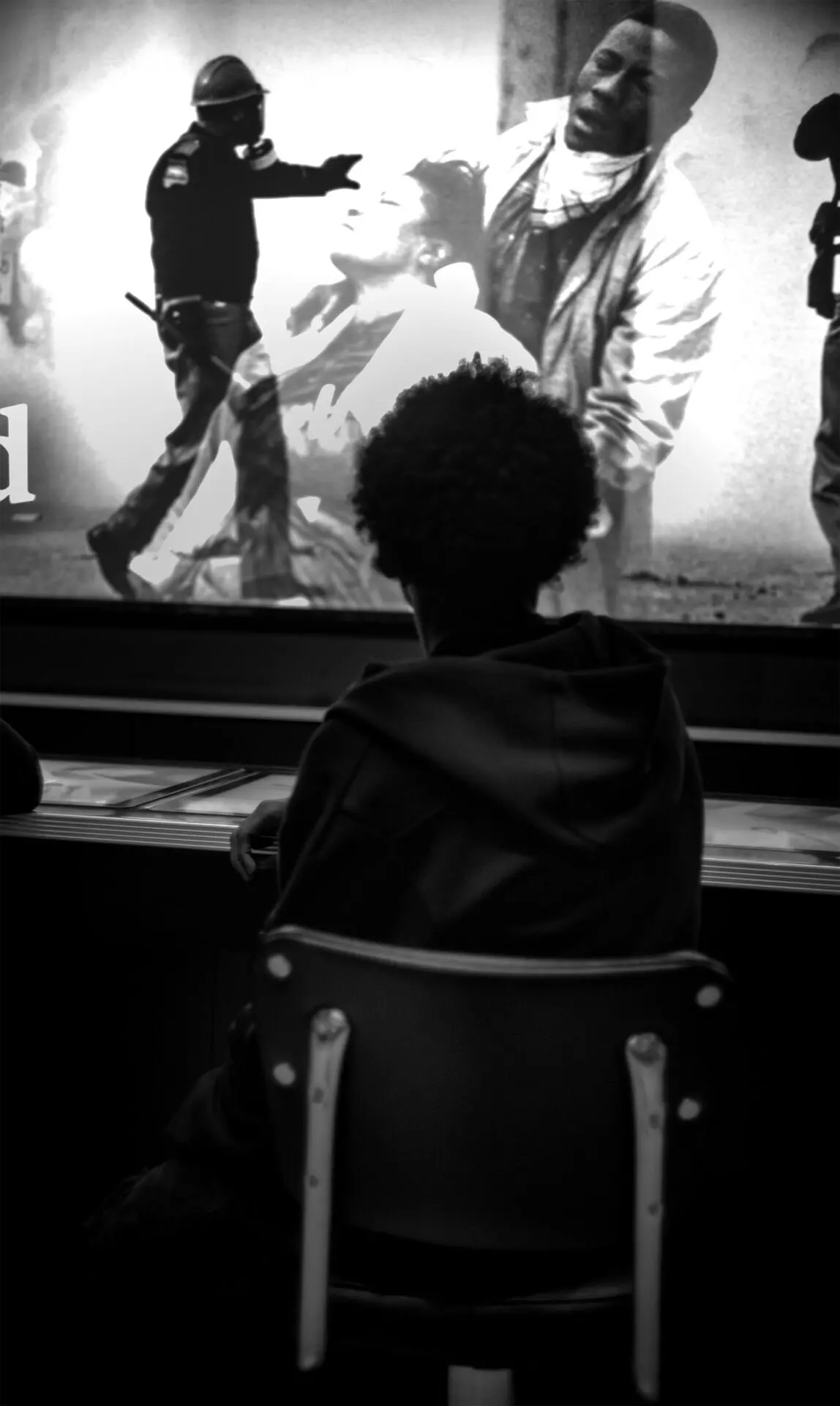A boy watching video of civil rights event in an American Afran Museum in 2nd floor